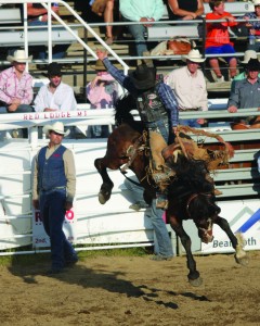 A Saddle Bronc Rider takes off