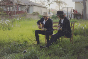 Folk artist Shakey Graves (left) and his guitarist Patrick O’Connor perform for “The Hatter” filmmakers in Graves’ Austin backyard in March. Graves is wearing a custom hat made by “The Hatter” Cate Havstad. PHOTO BY ERIC KUCINSKI