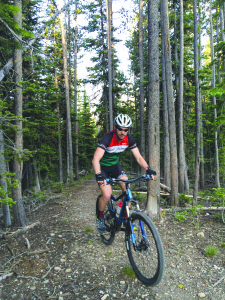 Nick Weiler pedals up the Ridge Trail while riding the North Fork Loop on July 2. PHOTO BY TYLER ALLEN
