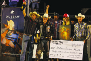 Stetson Lawrence, 26, was the top rider of this year’s PBR, coming in with a combined score of 175.5 points over the course of the two-day event. Here, Lawrence receives his guitar, trophy and check alongside Outlaw Partners staff and Andy Watson of Freestone Productions.