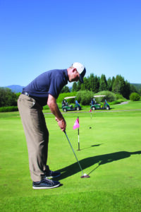 The pro displays proper body position, bending at the hips so his eyes are directly over the ball. PHOTO BY TYLER ALLEN