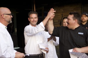 Peak's Restaurant Chef Wilson Wieggel looks on as Rainbow Ranch Chef Jake Irwin gives a high five to Huntley Lodge Chef Eric Holup.