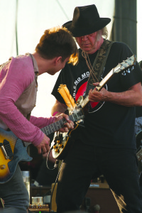 Neil Young and Lukas Nelson jam at the Harvest the Hope concert in Nebraska in September 2014. Image first published in the winter 2014-15 edition of Mountain Outlaw magazine. PHOTO BY DANIEL BULLOCK