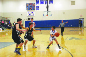 Freshman Kolya Bough, the Big Horns’ starting point guard, looks for an open shooter. The Big Horns had a strong first half, but lost momentum in the second half, leading to a 49-44 loss. PHOTO BY TYLER ALLEN.