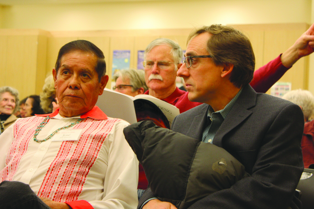 José Lucero (at left), longtime participant with the American Indian Institute, and Todd Wilkinson, who wrote the introduction to “Witness to Spirit,” wait to introduce Staffanson to a full house.