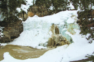 Sediment-laden effluent pours over Big Sky's iconic Ousel Falls the morning of March 4. OUTLAW PARTNERS PHOTO