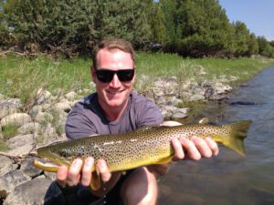 Practicing proper techniques for fish you plan to photograph and release ensures your catch will live to fight another day. PHOTO COURTESY OF GALLATIN RIVER GUIDES