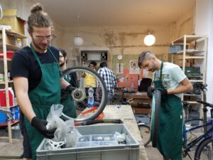 Oliver Voigt, left, searches for a bike part while Florian Lutz examines a tire on May 30, 2016. Voigt has been part of Rückenwind from the start and knows the shop better than almost anyone else.