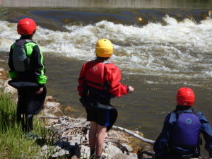 Wave Train Kayak Team members look for the best line through a rapid on the Jefferson River. 