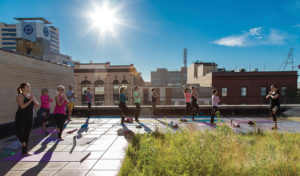 A Yoga class takes place on the green rooftop of downtown Fargo’s 102 Broadway, a Kilbourne Group renovation. PHOTO BY DAN FRANCIS