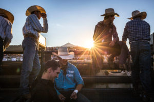 Sunset over Lone Mountain captures bull riders in their element. 