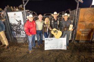 Nathan Schaper, pictured holding his first place Gibson guitar, won the Big Sky PBR for the second time in his career with a score of 92.5 in Saturday night's championship round. Standing with Schaper are (from left) are Chad Berger of Chad Berger Bucking Bulls, North Dakota Republican gubernatorial candidate Doug Burgum, Kathryn Helgaas, and Freestone Productions' co-owner Andy Watson.