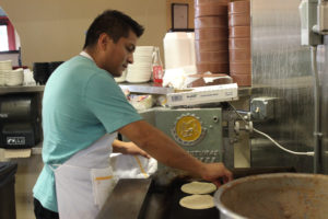 Alberto Godoy heats tortillas in the kitchen at his Mexican restaurant, Alberto’s, on Aug. 17. PHOTO BY JOSEPH T. O’CONNOR