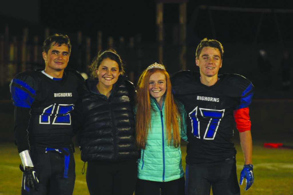 Homecoming King Eddie Starz and Queen Bella Butler pose with junior homecoming Prince Zach Cone and Princess Julia Barton after the Oct. 7 Lone Peak football game. PHOTO COURTESY OF BELLA BUTLER 