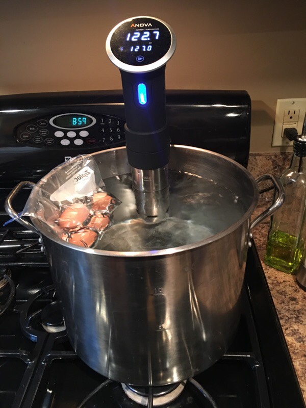 Soft boiled eggs heating up to temperature in a sous vide water bath. Since eggs already have a shell that makes them inpenatrable by water, a ziploc bag rather than a true vacuum sealed bag will do the trick. PHOTO BY MARK BIRKMEIER 