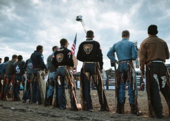 Cowboys stand for the national anthem at the 14th annual Big Sky PBR. PHOTO BY TAYLOR ALLEN/OUTLAW PARTNERS
