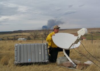 In this 2006 photo, a National Weather Service employee positions a dish used to download weather data. PHOTO COURTESY OF NOAA