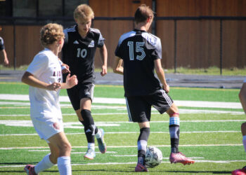 Junior captain Sidney Morris and sophomore Thaddeus Davis move the ball in front of the Lockwood Lions' goal. PHOTO BY JEN CLANCEY
