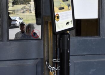 "Animals are dangerous" reads a sign positioned near an entrance to the Mammoth Hot Springs Visitor Center in Yellowstone National Park that had been locked on Oct. 1, 2025. PHOTO BY AMANDA EGGERT