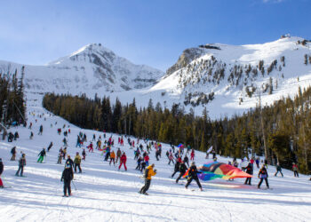 Participants carry a giant flag down Mr. K during the 2026 event. PHOTO BY CARLI JOHNSON