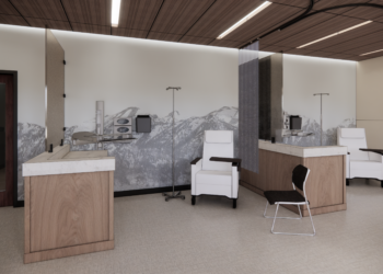 Treatment stations in a modern clinic with white chairs, IV poles, and a mountain mural on the wall