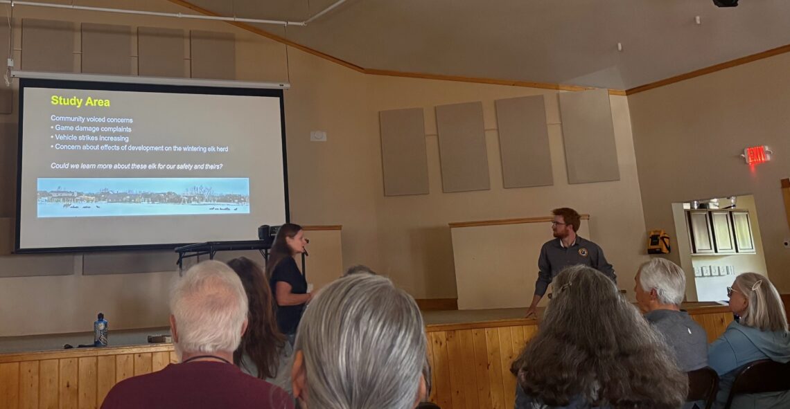 Presentation in a meeting hall: slide titled 'Study Area' with bullets on community concerns; two presenters stand near screen as audience listens.