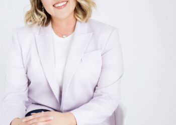 Professional portrait of a smiling woman in a pale blazer seated against a light background, with the Stone Leaf Financial logo visible to her right.